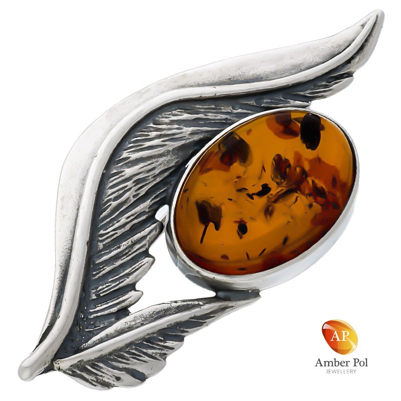 Broszka srebrna 925 z bursztynem w kolorze koniaku otoczonym srebrnymi listkami.