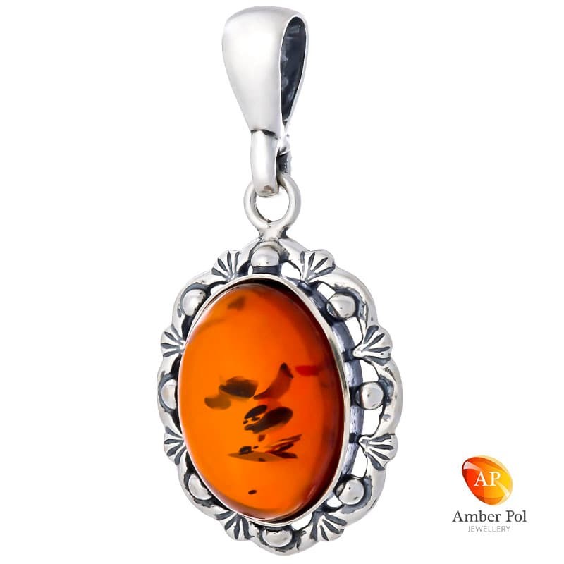 Wisiorek ze srebra 925 z bursztynem w kolorze koniaku ozdobionym delikatnie kuleczkami i ażurowym wzorem.