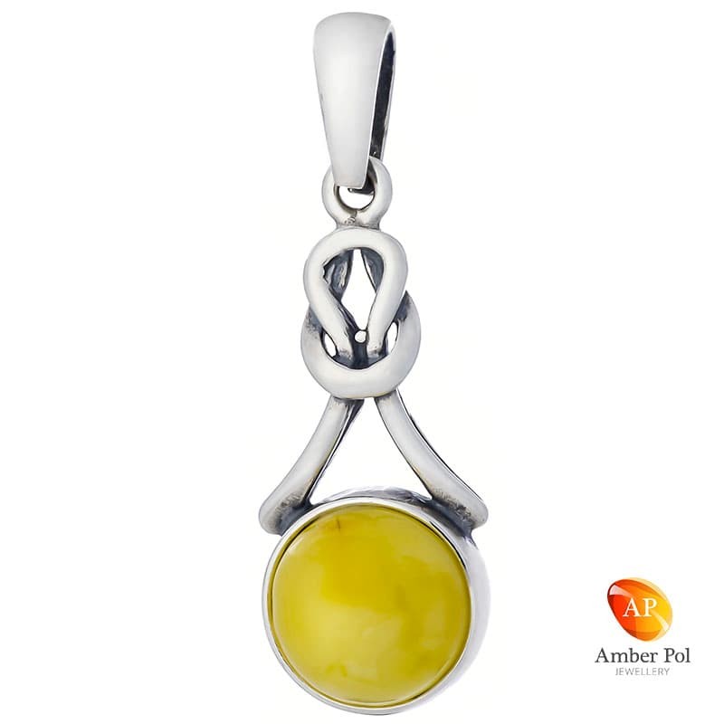 Wisiorek ze srebra 925 w lekko wydłużonej formie z okrągłym  bursztynem w kolorze mlecznym ze zdobieniem w kształcie pętelki.