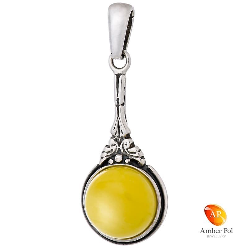 Piękny wisiorek srebrny 925 z   bursztynem w kolorze białym, delikatne zdobienie i wydłużony kształt dodaje elegancji.