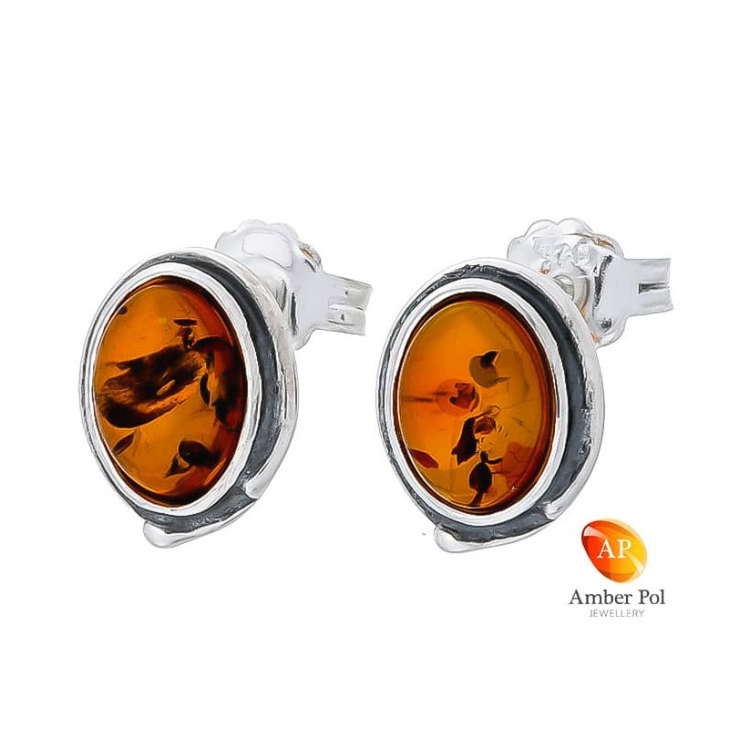 Piękne kolczyki na sztyft ze srebra próby 925 o kształcie owalu z bursztynem w koniakowym kolorze.