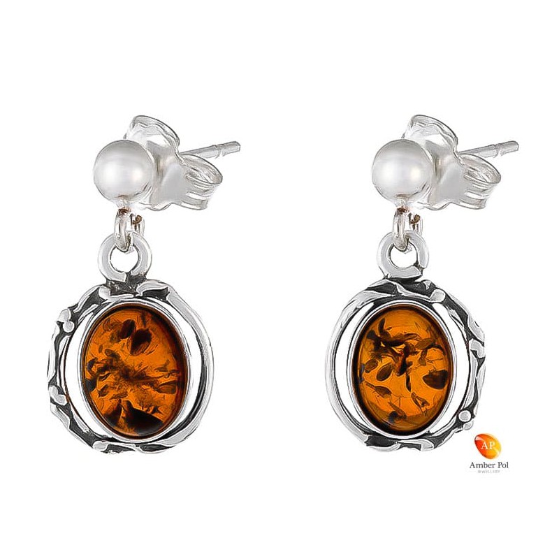 Kolczyki wiszące ze srebra 925 na zawieszce typu sztyft z kulką i  owalnym  bursztynem w kolorze koniakowym.