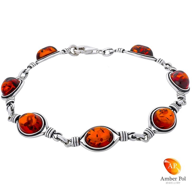 Piękna srebrna bransoletka próby 925 z 7 elementami i bursztynami w koniakowym kolorze.