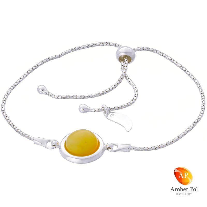 Bransoletka srebrna 925 ściągana i regulowana z  okrągłym bursztynem w białym kolorze.