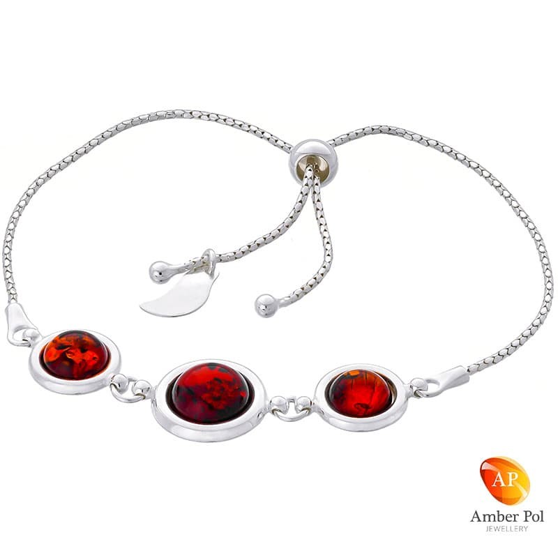 Bransoletka srebrna 925 ściągana i regulowana z  trzema okrągłymi bursztynami  w koniakowym kolorze.
