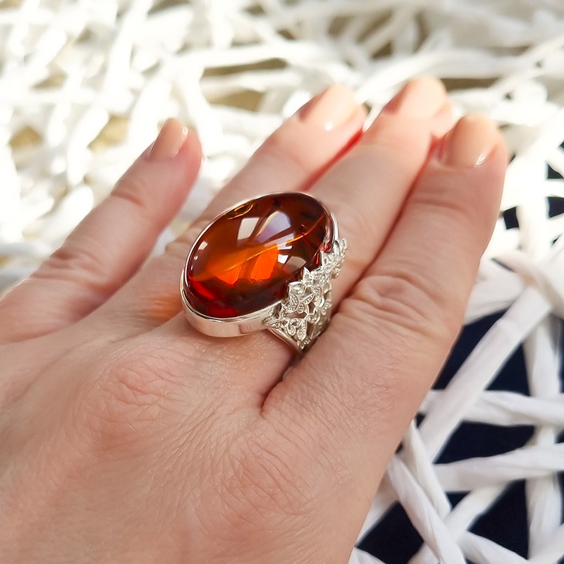 Unikatowy pierścionek ze srebra 925 z bocznym ażurowym zdobieniem i koniakowym bursztynem.